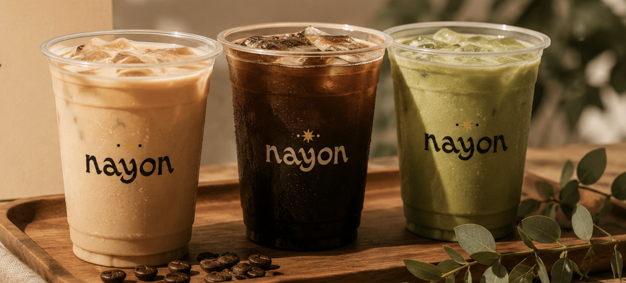 Nayon iced drinks — caramel latte, brewed iced coffee, and matcha, served in branded cups